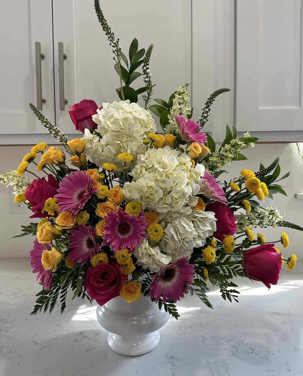 Funeral flower arrangement in vase by Blooms and Wishes, a florist located in Columbia, MO