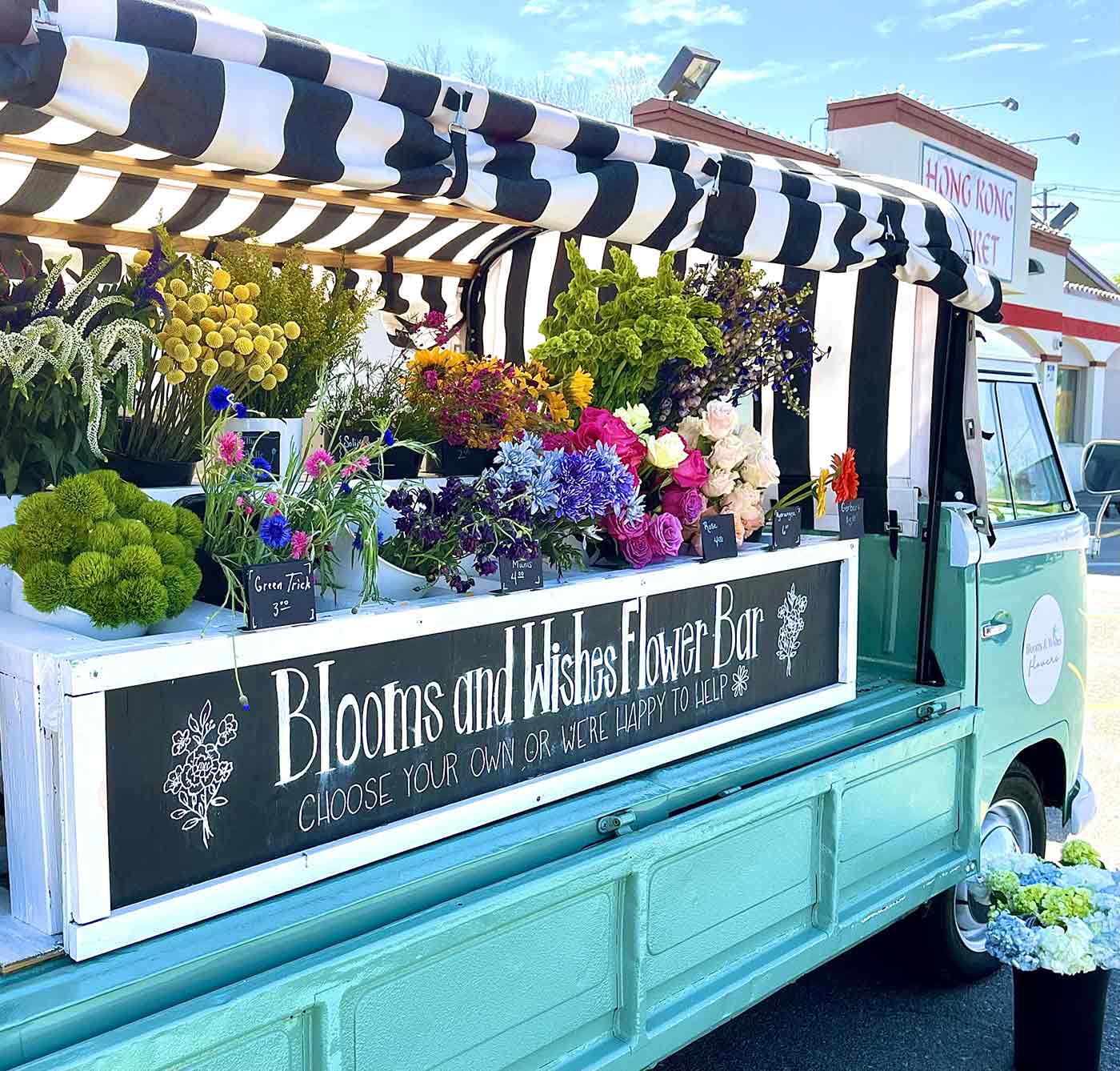 Sallie the Stem Bar Truck filled with flowers in in front of a Columbia, MO store